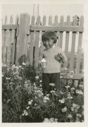 Image of Young Eskimo [Inuk] boy in flower garden - arctic poppies, etc.